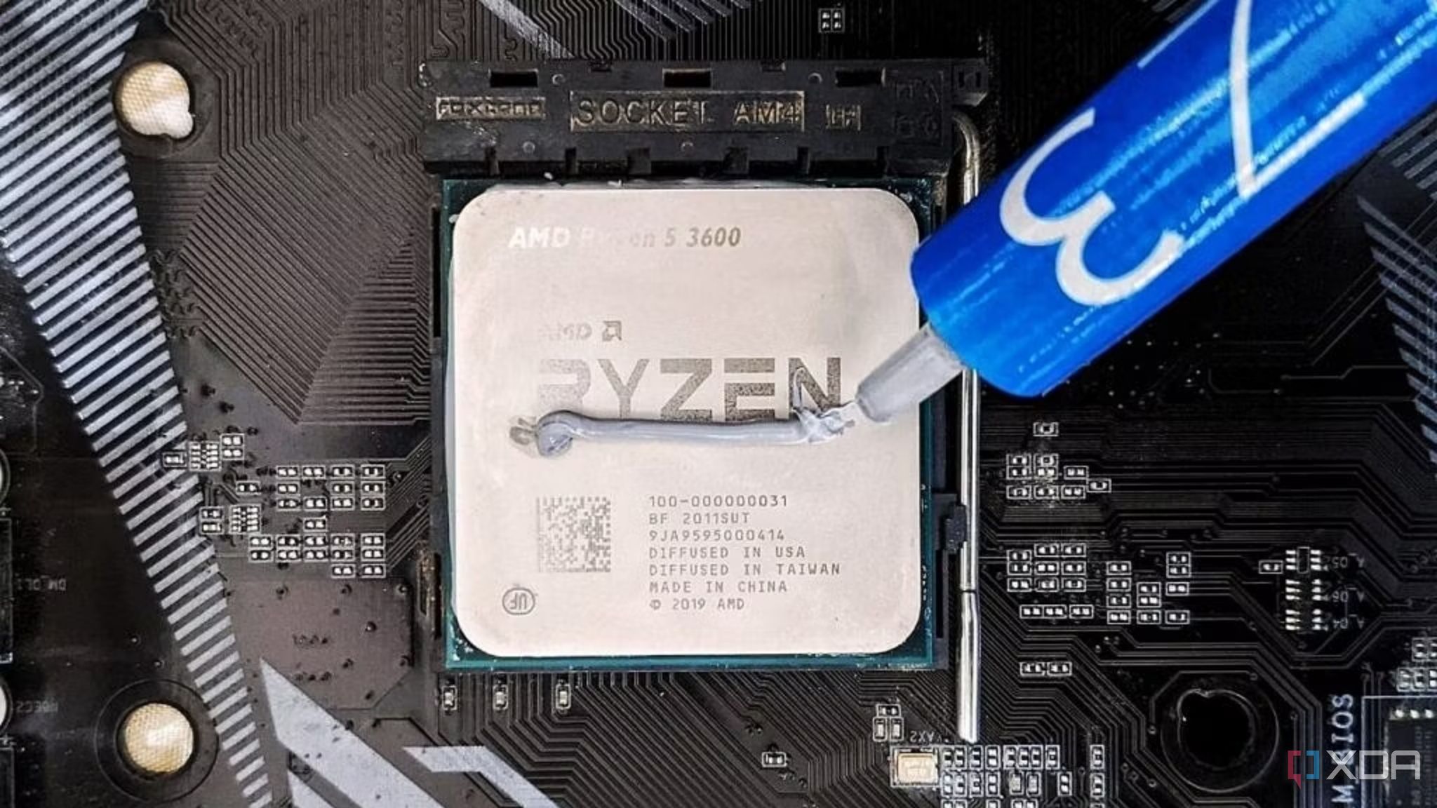 На фотографии изображен процессор AMD Ryzen 5 3600 с термопастой.